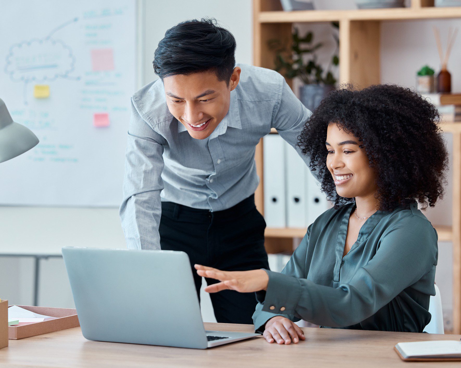 Two colleagues collaborating at a laptop.